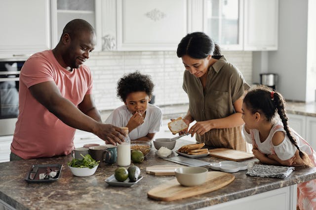 A family making a meal in the kitchen.