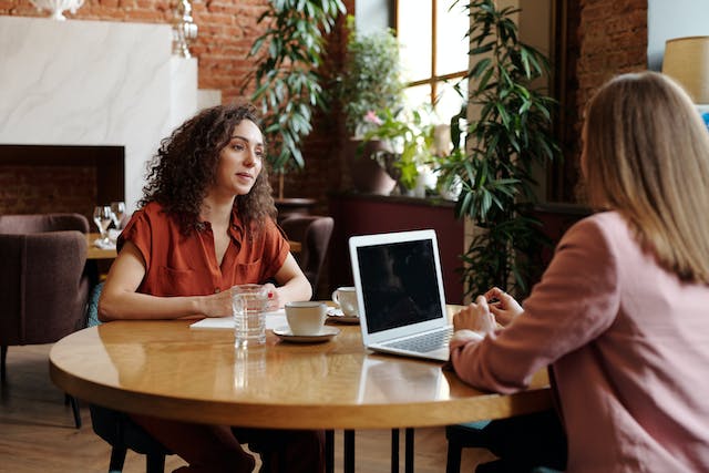 Two people sitting at a table.