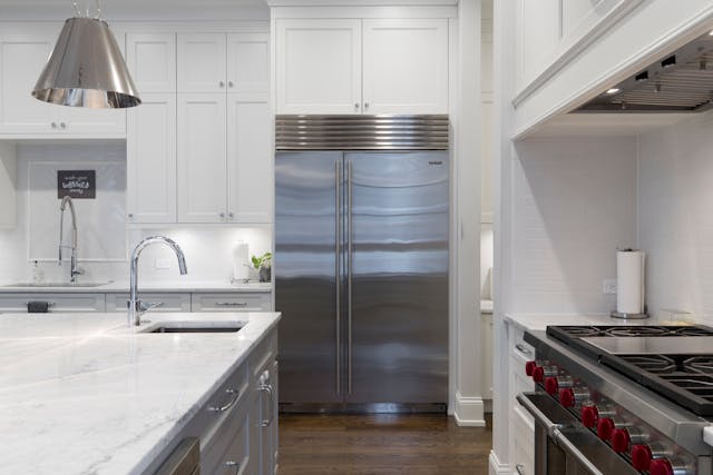 A modern kitchen with a stainless steel fridge.