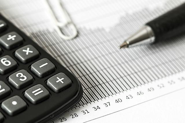 A close-up of a calculator and a pen.
