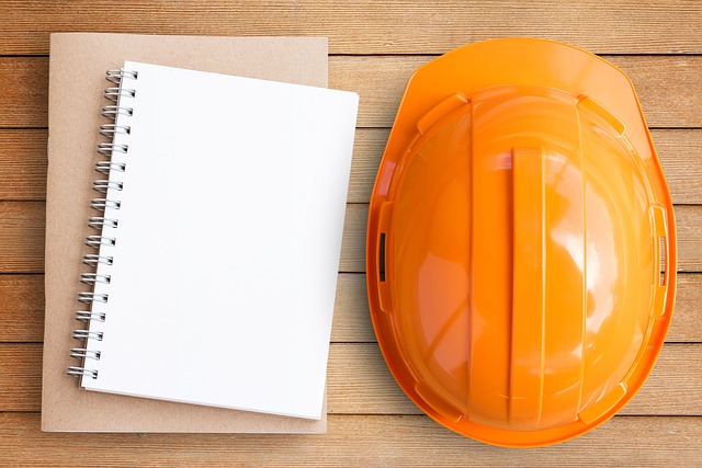 notepad and orange hard hat