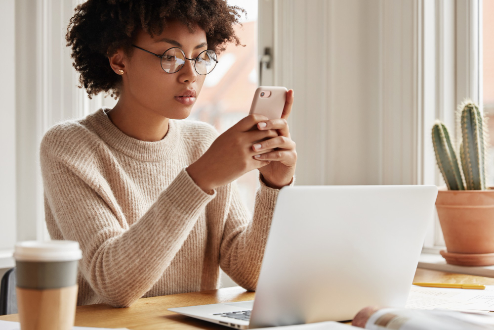 person on phone and laptop