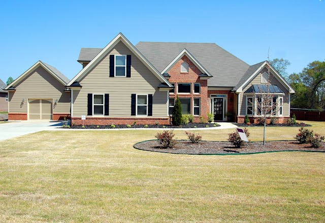 A home with a large front lawn.