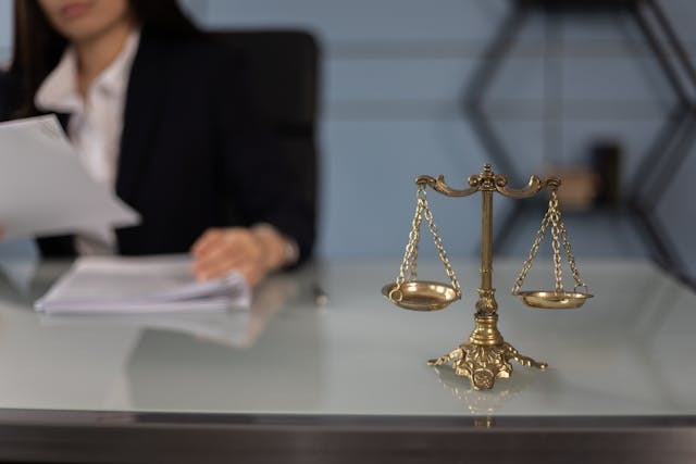 A Golden Balance Scale beside a Laptop
