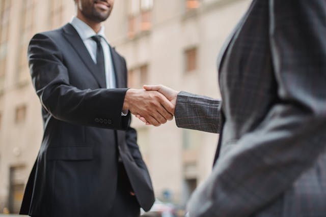two people in suits shaking hands