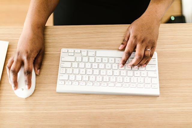 a person typing on their computer