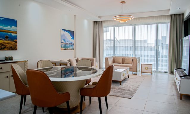 a brightly lit apartment with a furnished living room