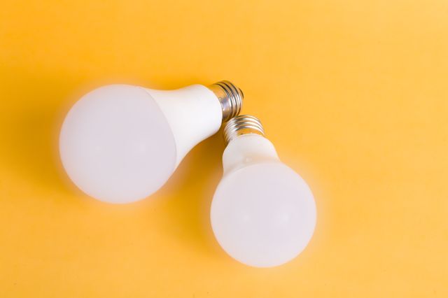 two lightbulbs on a yellow background