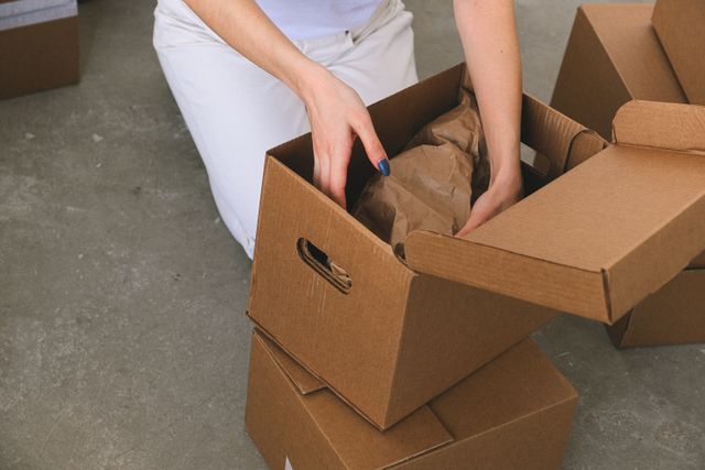 a person packing moving boxes